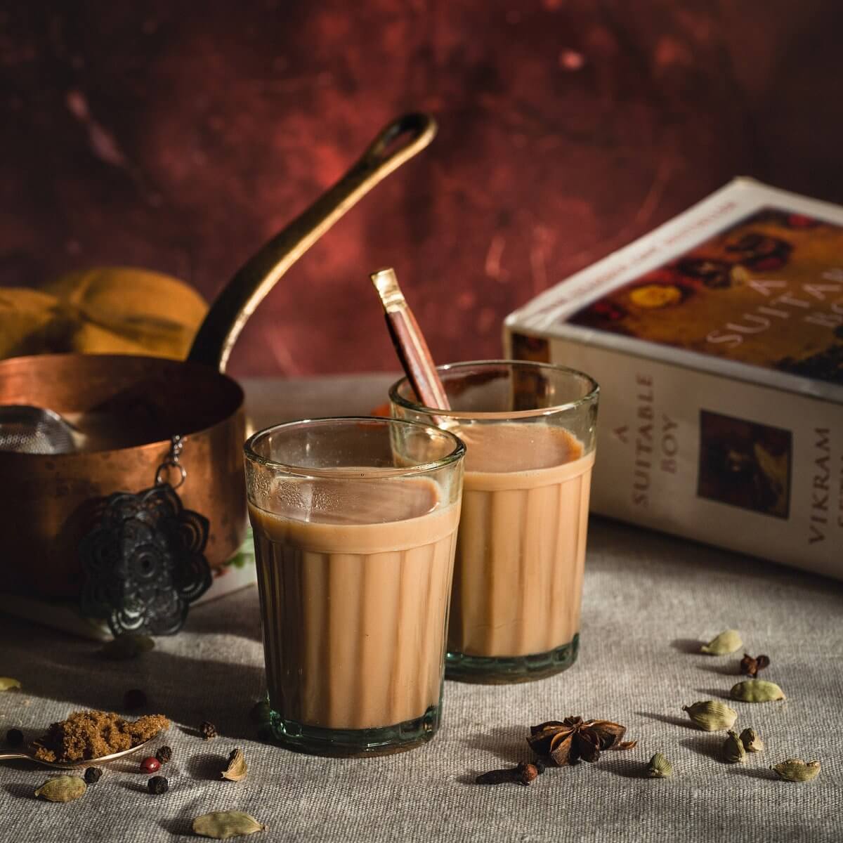 two cups of chai tea with Indian spices and book