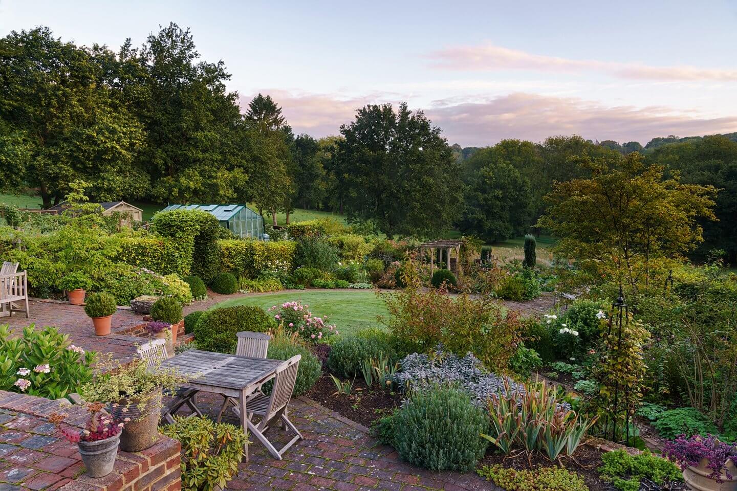 the English Garden magazine Surrey good life article lead image of private godalming garden at sunrise