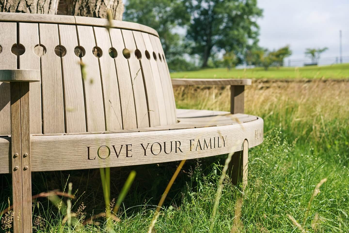 bespoke inscription love your family on a wooden tree seat