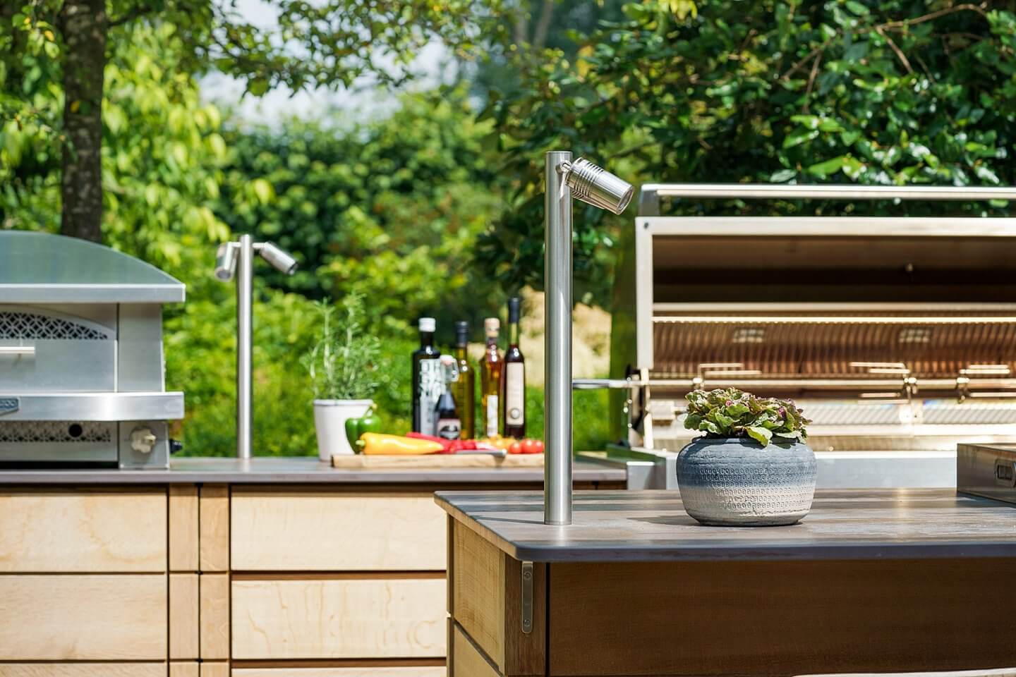 outdoor kitchen with lighting, rotisserie, pizza oven