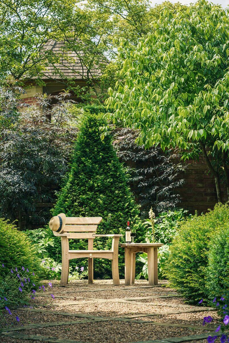 May Throne with side table wooden garden furniture in a UK garden