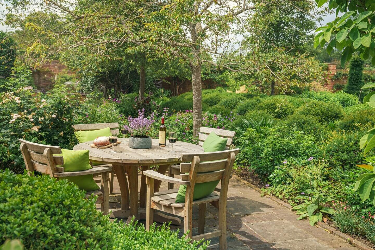 Bailey table and chairs wooden handcrafted in the UK in an English country garden