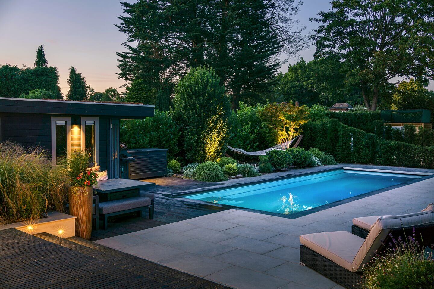 family pool garden with lighting at twilight designed by Helen Rose Wilson