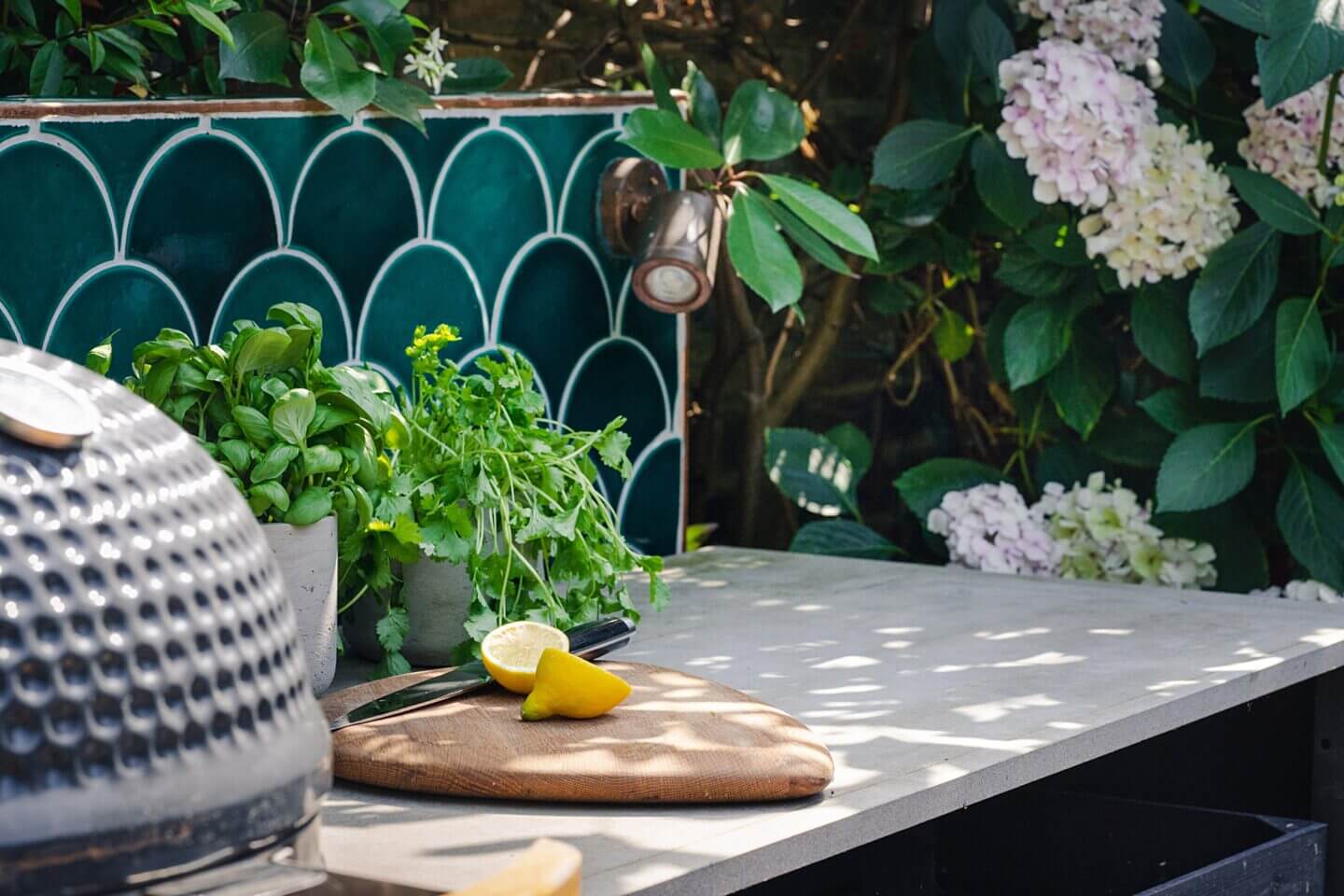 Art Deco green tiles and Hydrangea with outdoor kitchen in a family garden