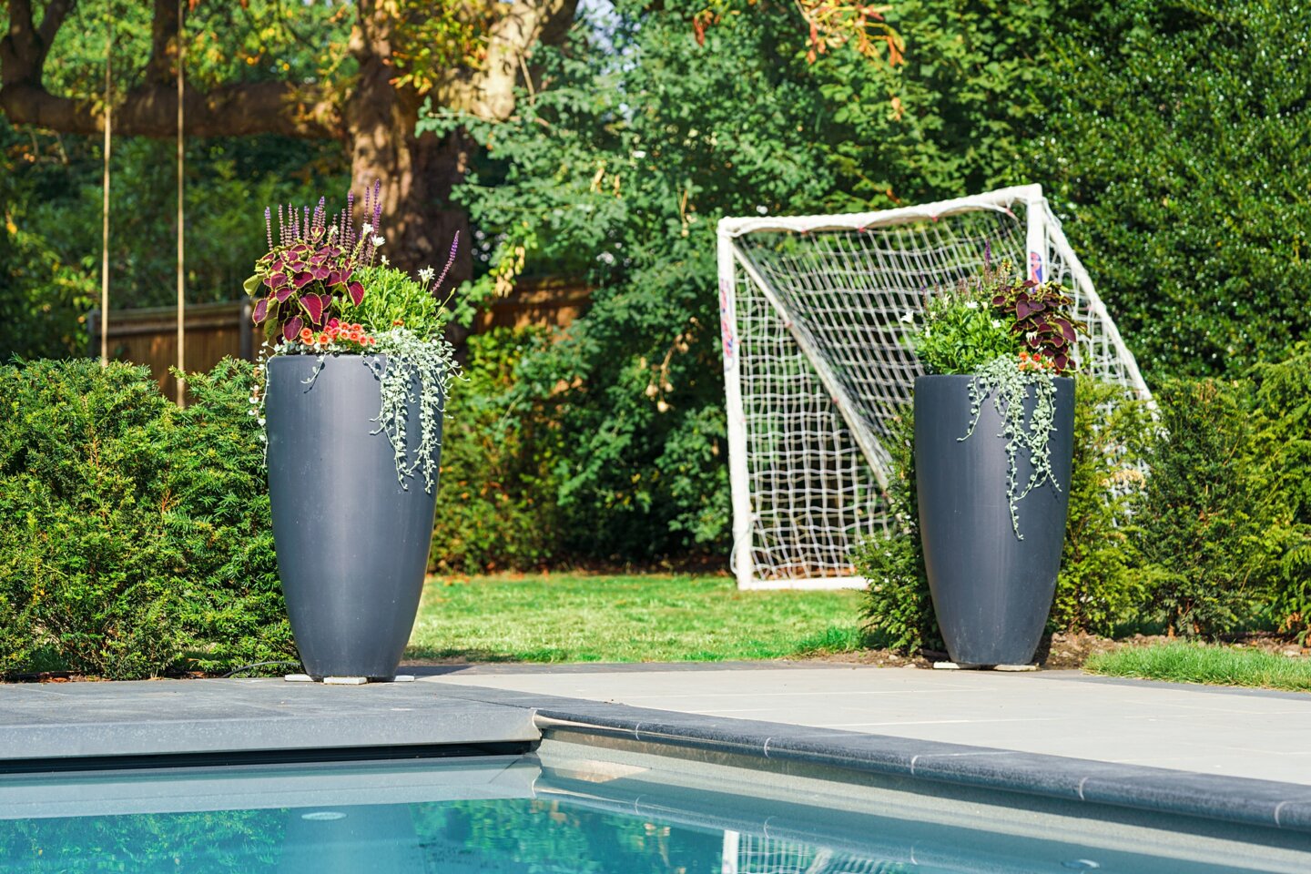 Tall planters as a garden feature with lawn area and football goalposts beyond