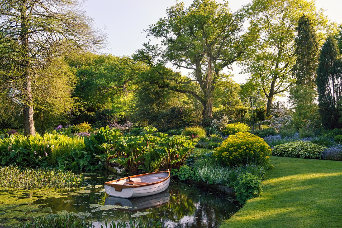 Ornamental boat in May at the Water Gardens of Beth Chatto