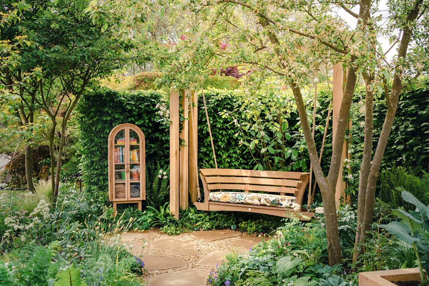 Swing bench crafted in oak in a garden
