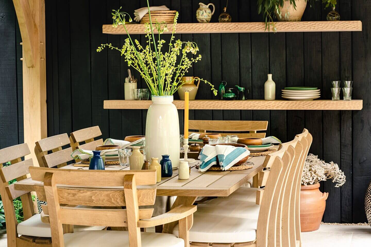Outdoor oak dining table and seating styled by Wildstone Floral and Lamb & Newt