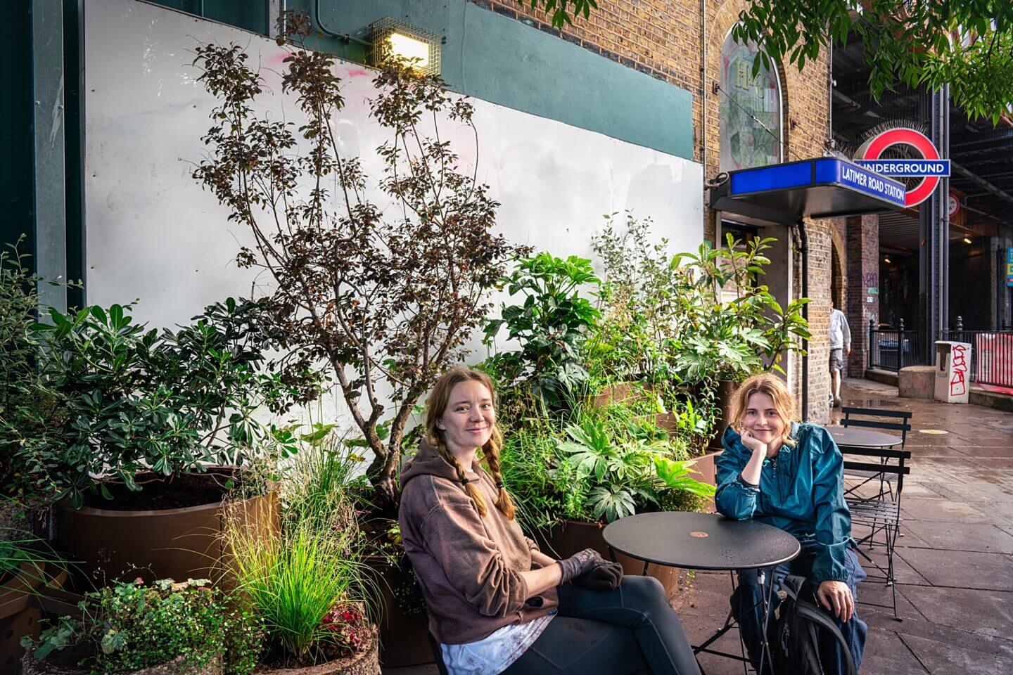 Emilie Bausager and Amelia Bouquet garden designers outside their container garden at Latimer Road tube station
